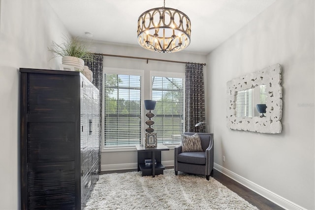 living area featuring dark hardwood / wood-style floors and an inviting chandelier