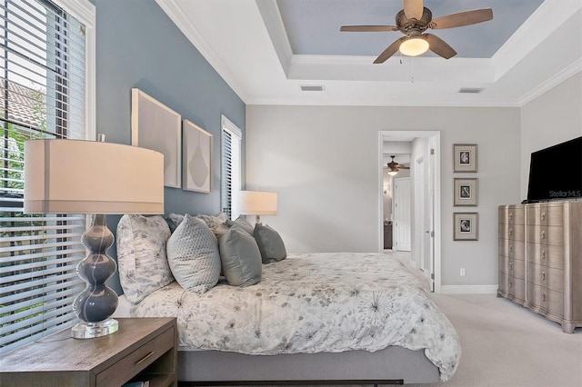 bedroom featuring a raised ceiling, ceiling fan, light carpet, and ornamental molding