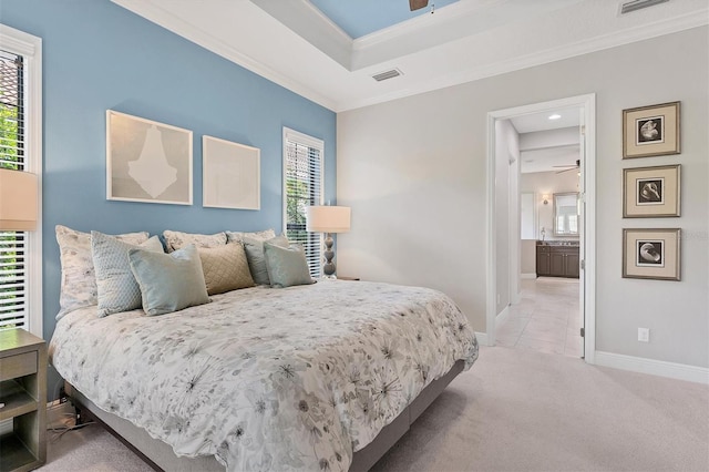 bedroom with ensuite bath, crown molding, light colored carpet, and multiple windows