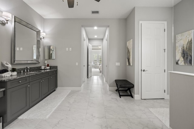 bathroom with ceiling fan and vanity