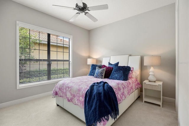 bedroom with ceiling fan and light carpet