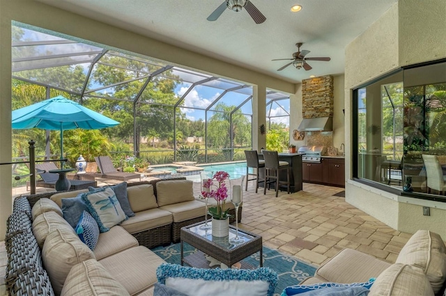 sunroom / solarium with ceiling fan and a swimming pool