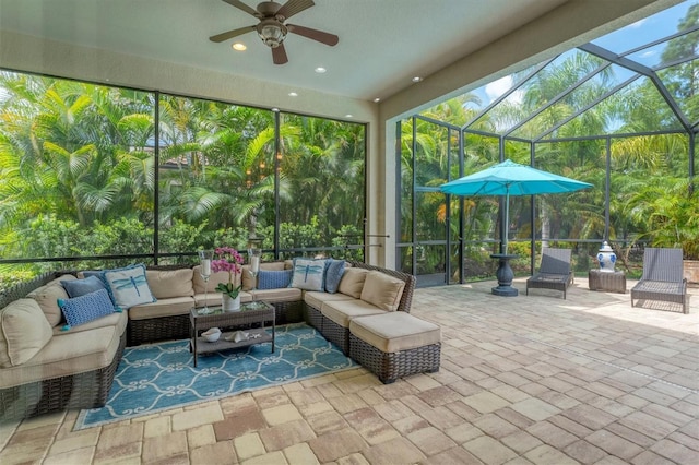 sunroom / solarium featuring ceiling fan