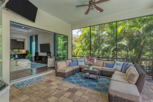 sunroom / solarium featuring ceiling fan