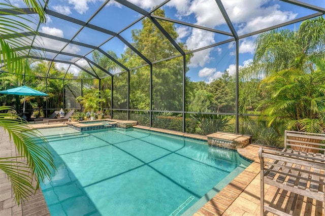 view of swimming pool featuring glass enclosure, an in ground hot tub, and a patio