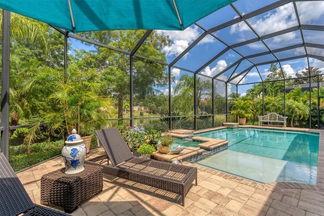 view of pool featuring a lanai, an in ground hot tub, and a patio