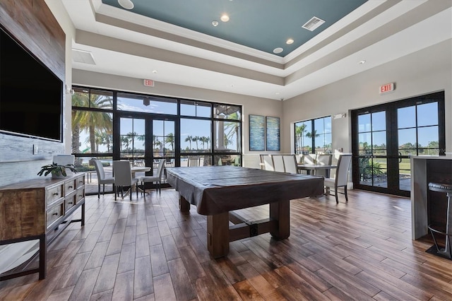 rec room featuring french doors, a high ceiling, a raised ceiling, crown molding, and pool table