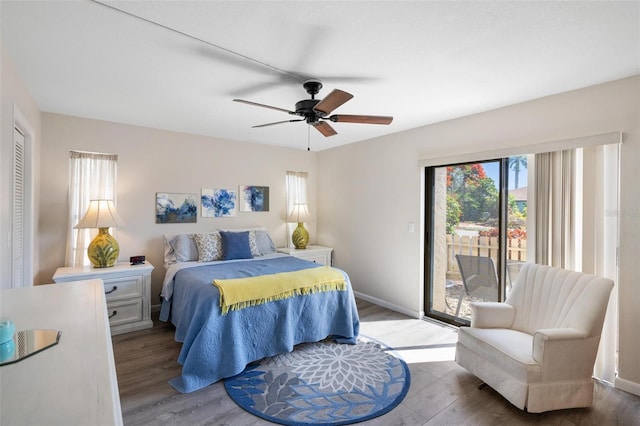 bedroom featuring ceiling fan, access to exterior, wood-type flooring, and a closet