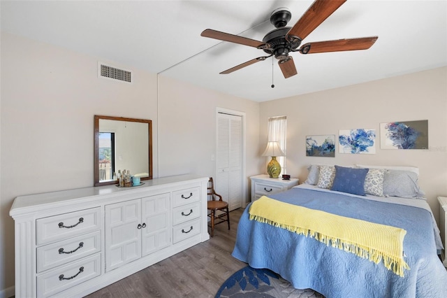 bedroom featuring ceiling fan, light wood-type flooring, multiple windows, and a closet