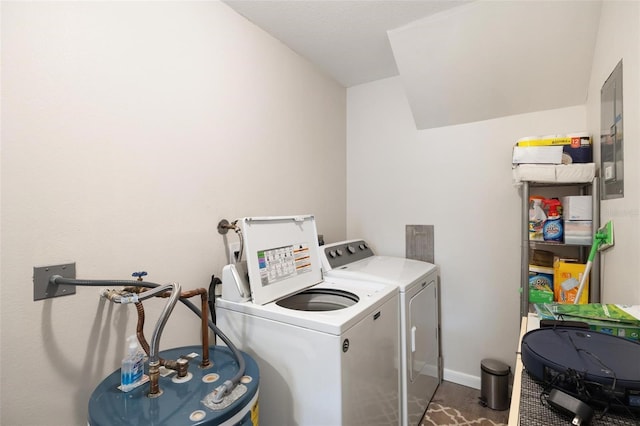 washroom featuring washer and dryer, dark hardwood / wood-style flooring, and water heater