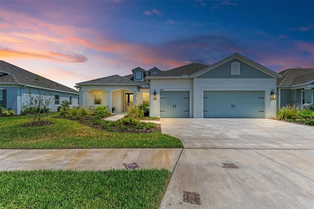 view of front of property featuring a garage and a lawn