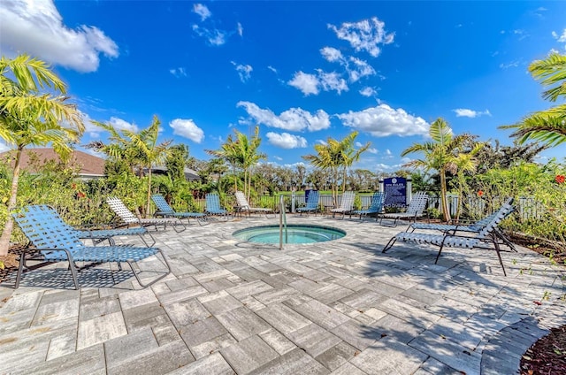 view of pool featuring a hot tub and a patio