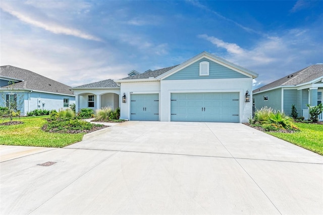 view of front of property with a garage and a front lawn