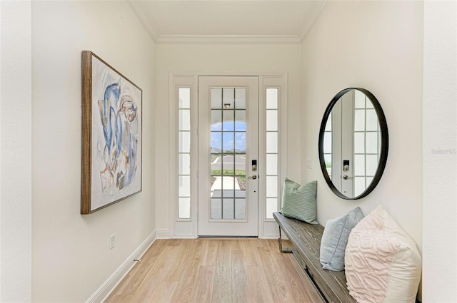 foyer featuring crown molding and light hardwood / wood-style floors