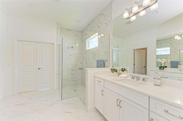 bathroom with crown molding, vanity, and a tile shower