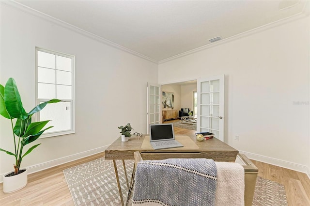 home office featuring crown molding and light wood-type flooring