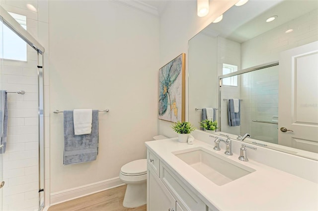 bathroom featuring wood-type flooring, toilet, an enclosed shower, and vanity