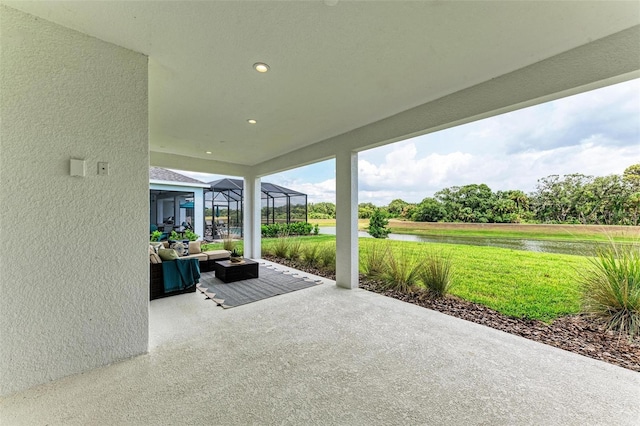 view of patio featuring a water view, an outdoor hangout area, and glass enclosure