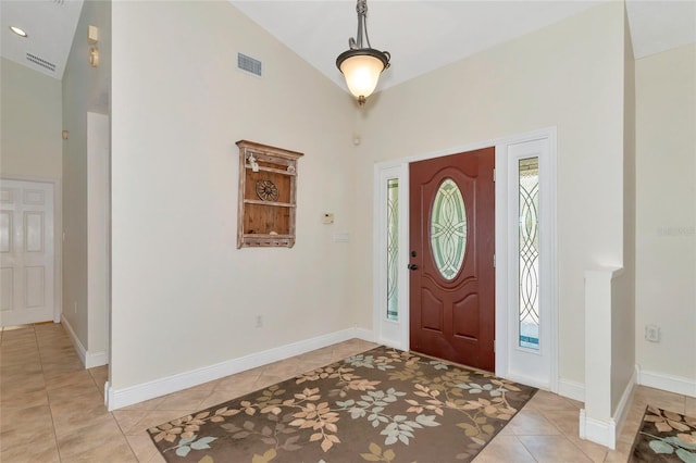 foyer with lofted ceiling and light tile patterned floors