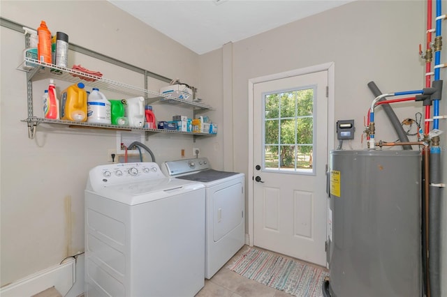 washroom with water heater, light tile patterned flooring, and separate washer and dryer