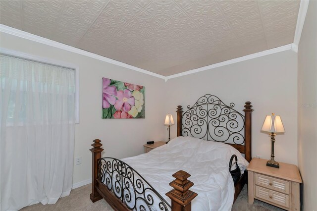 bedroom with ornamental molding, light colored carpet, and a textured ceiling