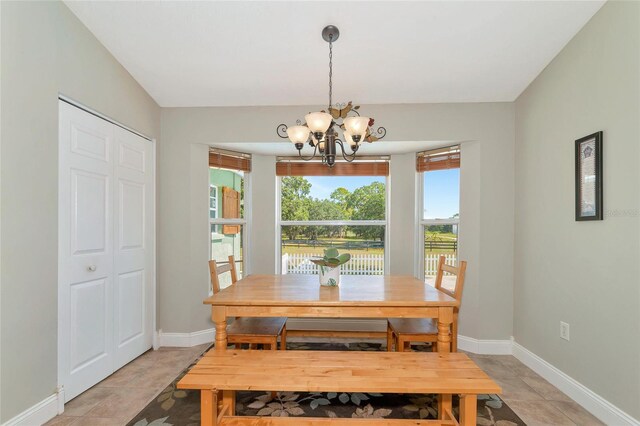 dining area featuring a chandelier and light tile patterned floors