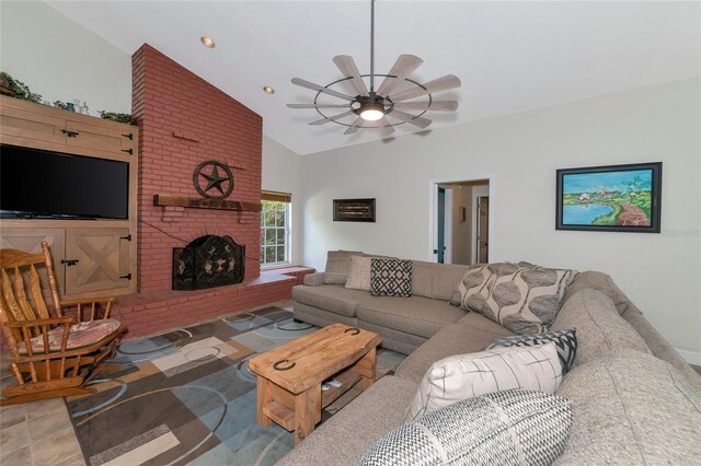 living room featuring vaulted ceiling, a fireplace, and ceiling fan