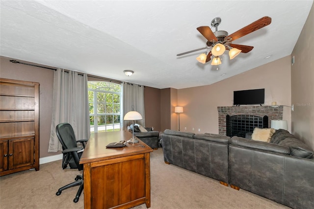 living room featuring vaulted ceiling, light colored carpet, ceiling fan, a fireplace, and a textured ceiling