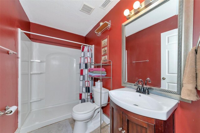 bathroom with toilet, tile patterned flooring, a shower with shower curtain, and vanity