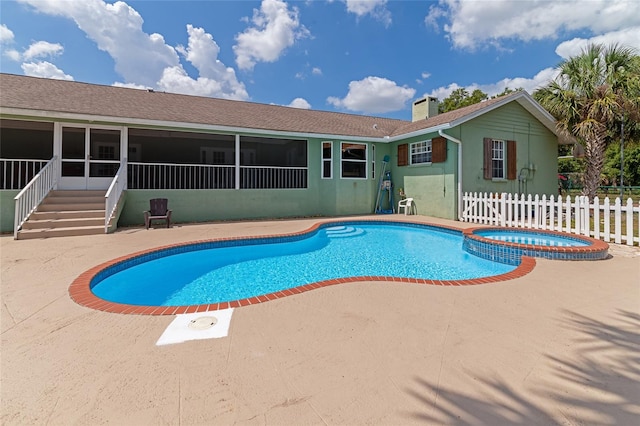 view of swimming pool featuring an in ground hot tub, a sunroom, and a patio area