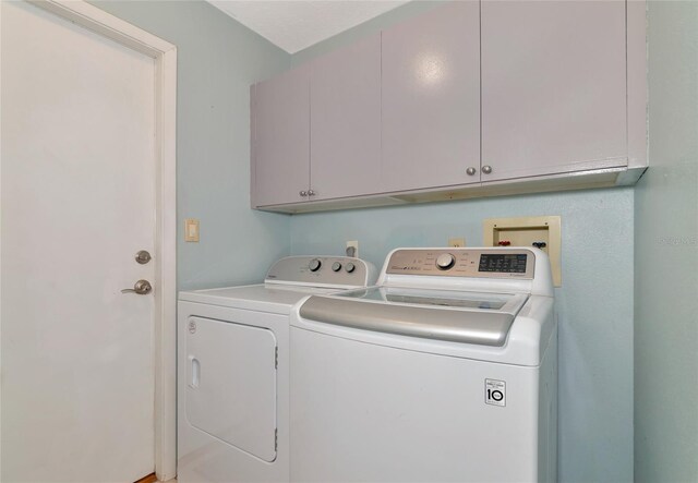 laundry area with cabinets and independent washer and dryer