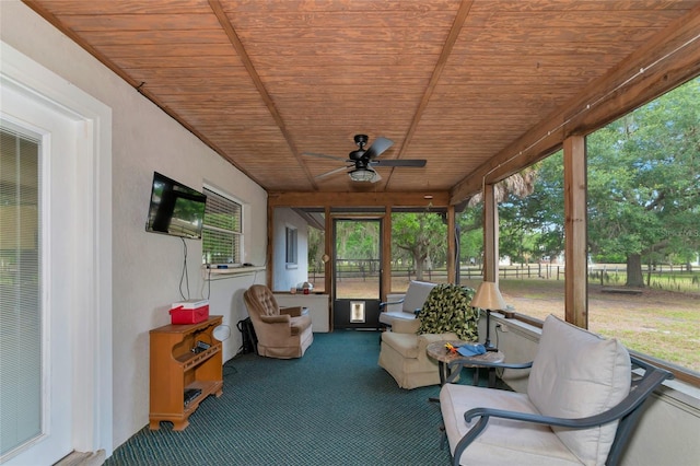 unfurnished sunroom with ceiling fan and wood ceiling