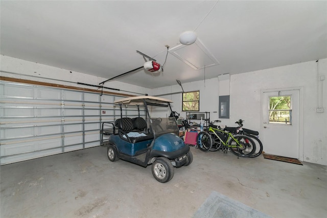 garage featuring electric panel and a garage door opener