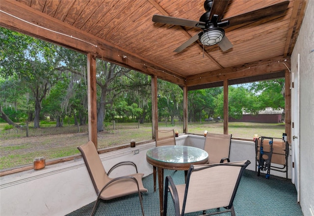 sunroom / solarium featuring ceiling fan