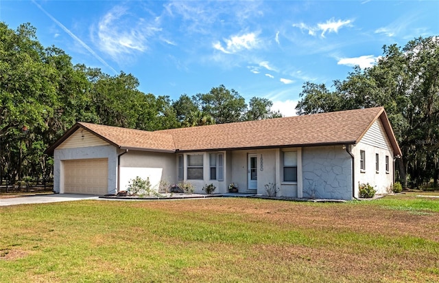 ranch-style house with a garage and a front yard