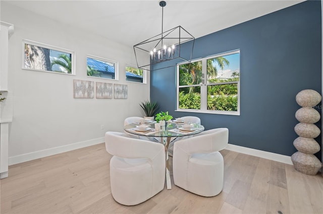 dining room featuring light hardwood / wood-style floors and a notable chandelier