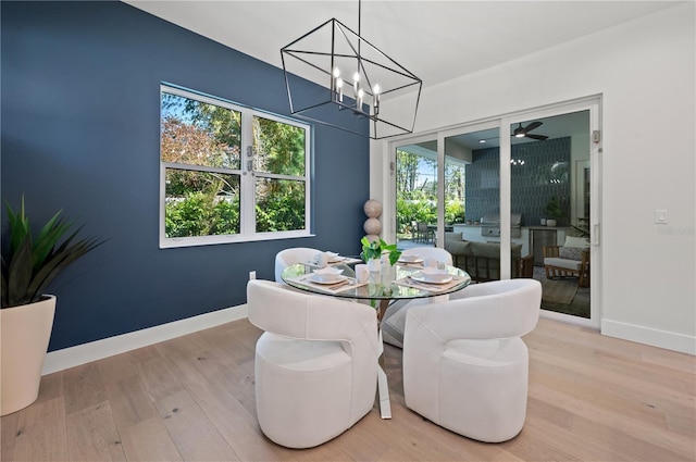 dining space featuring hardwood / wood-style floors and an inviting chandelier