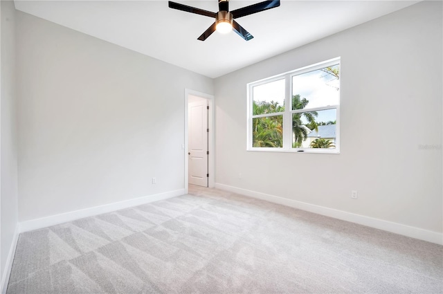 unfurnished room with light colored carpet and ceiling fan