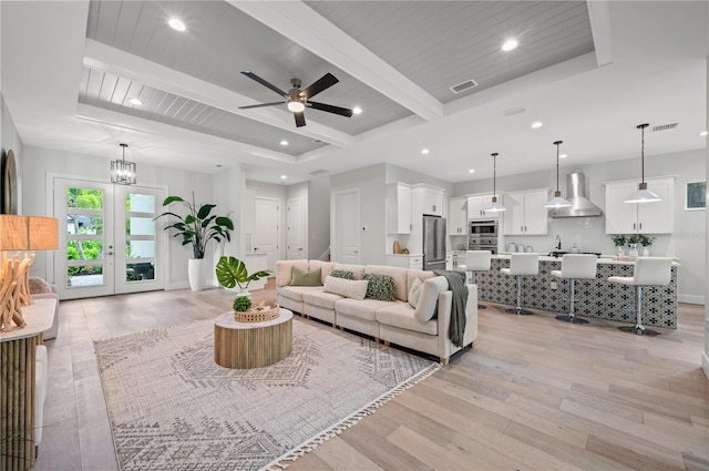 living room with wooden ceiling, beam ceiling, ceiling fan with notable chandelier, and light wood-type flooring