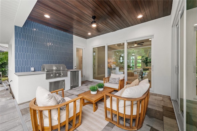 view of patio / terrace featuring ceiling fan, an outdoor kitchen, a grill, and an outdoor hangout area