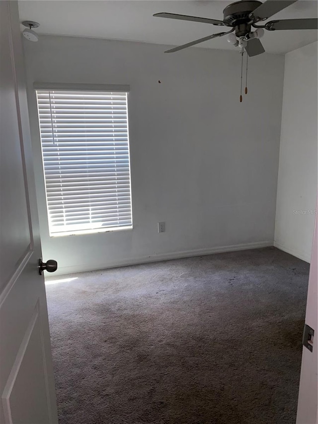 carpeted empty room with plenty of natural light and ceiling fan