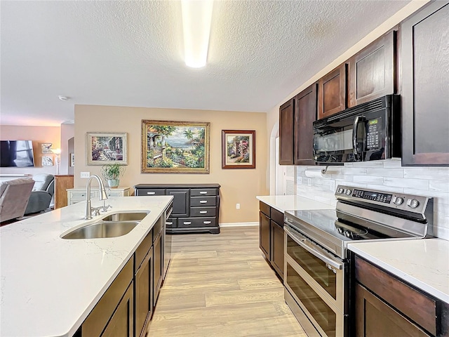 kitchen featuring stainless steel range with electric stovetop, sink, decorative backsplash, a textured ceiling, and dark brown cabinetry