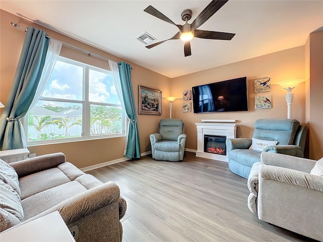 living room with ceiling fan and light hardwood / wood-style floors