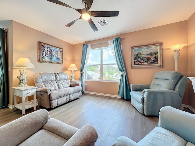 living room with ceiling fan and light hardwood / wood-style floors