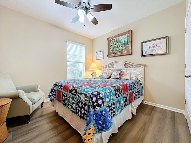 bedroom with ceiling fan and dark hardwood / wood-style floors