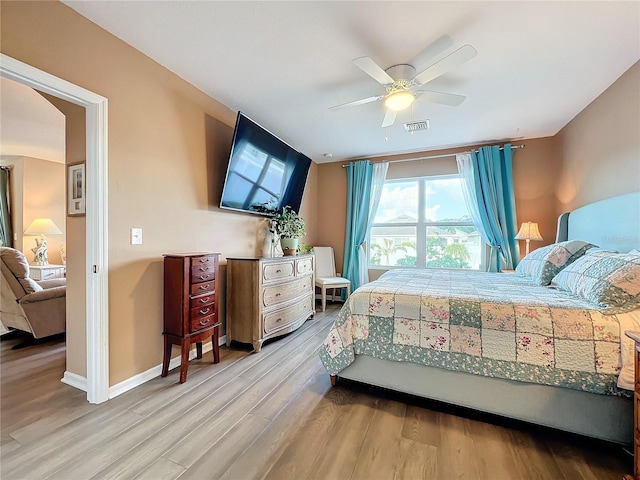 bedroom with ceiling fan and light hardwood / wood-style floors