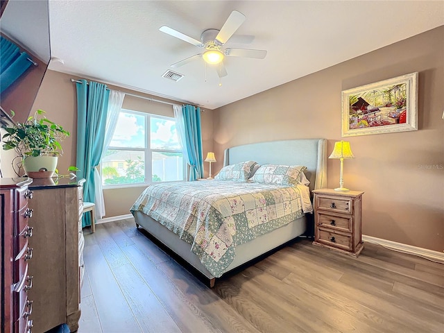 bedroom featuring wood-type flooring and ceiling fan