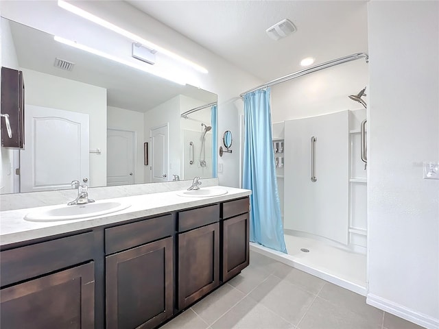 bathroom with tile patterned flooring, vanity, and walk in shower