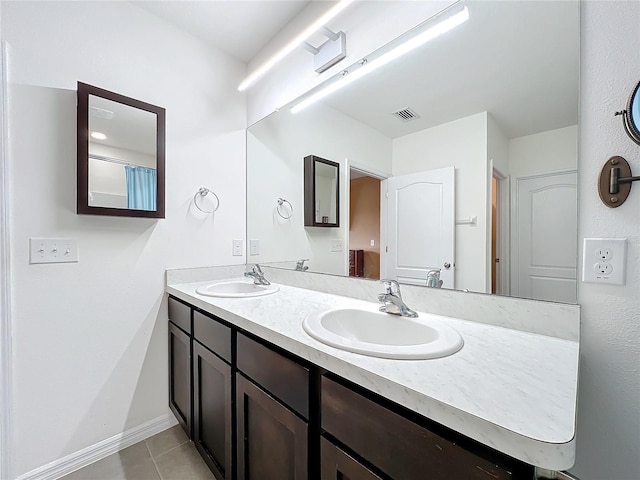 bathroom with tile patterned flooring and vanity