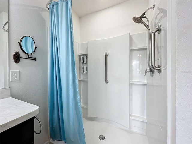 bathroom featuring curtained shower and vanity